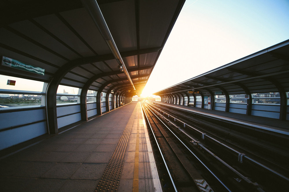 train station platform with sunrise on horizon