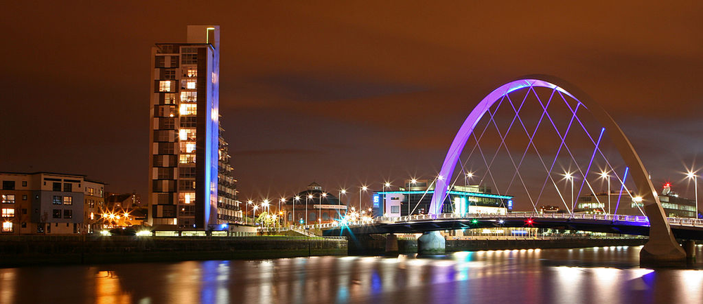 Nightime scene of city with bridge and high rise building