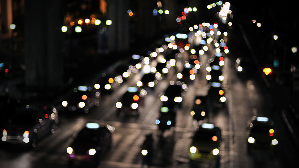 cars on motorway at night with illuminated headlights