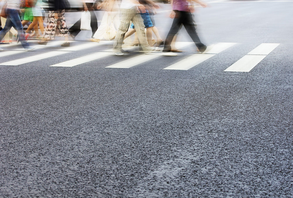 People walking across zebra pedestrian crossing