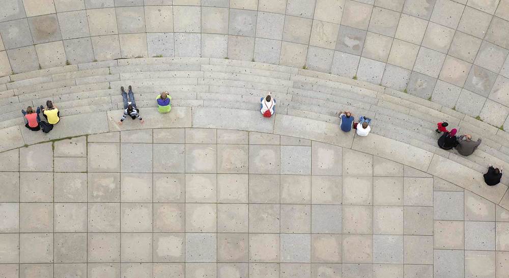 view from above of stone steps with a few people sitting on the steps